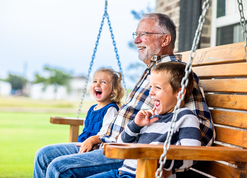 Grandpa and grandkids sitting in a porch swing